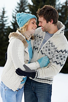 Young Couple In Alpine Snow Scene