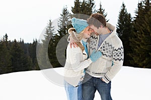 Young Couple In Alpine Snow Scene