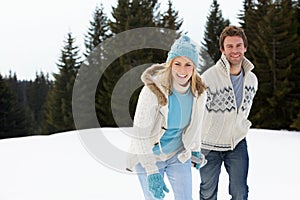 Young Couple In Alpine Snow Scene