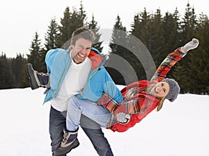 Young Couple In Alpine Snow Scene