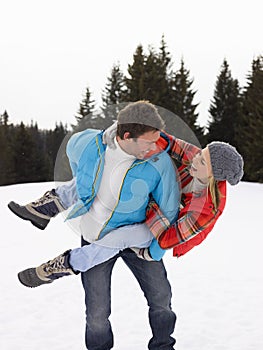 Young Couple In Alpine Snow Scene