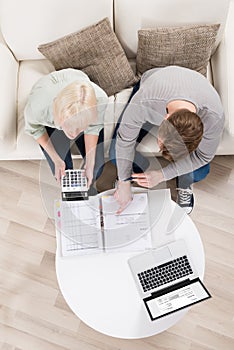 Young Couple Analyzing Invoices