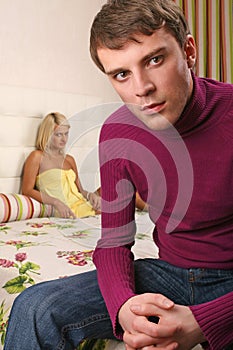 Young couple argue in bedroom photo