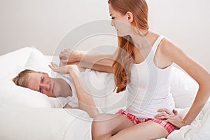 Young couple arguing in bed