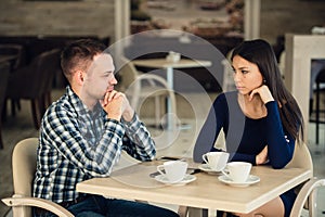 Young couple arguing in a cafe. Relationship problems.