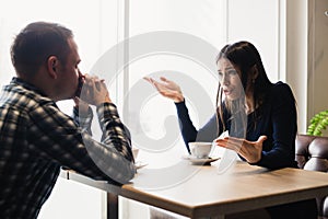 Young couple arguing in a cafe. Relationship problems.