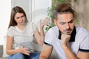 Young couple arguing in living room.