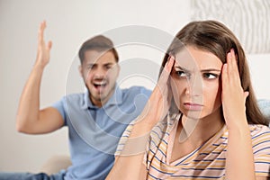 Young couple arguing in living room.