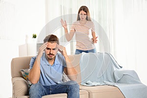 Young couple arguing in living room.