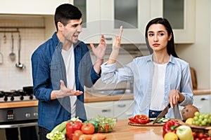 Young couple arguing in the modern kitchen