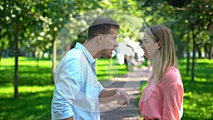 Young couple arguing outdoor, family misunderstanding, emotional abuse, conflict photo