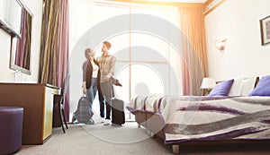 Young couple arrived to hotel room on honeymoon