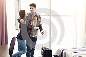 Young couple arrived to hotel room on vacation