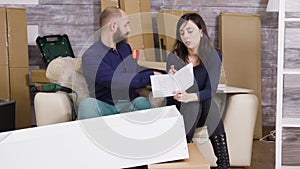 Young couple assembling a shelf as a team