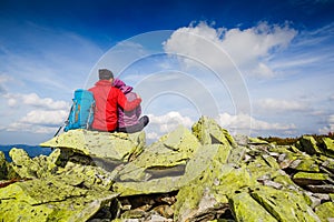 Young couple with backpack relaxing in the mountains. Mountaineering, healthy lifestyle