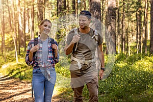 Young couple â¬with backpacks on a hike in forest. backpacking trip, summer adventure vacation