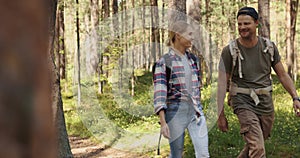 Young couple â¬with backpacks on a walk in forest. backpacking trip, summer adventure hike