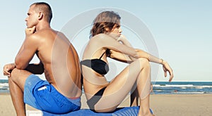 young couple in bad mood on beach vacation.