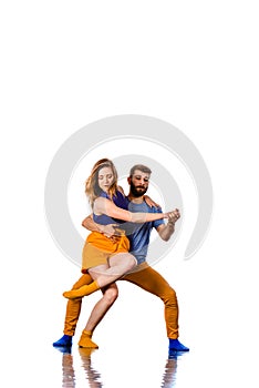 Young couple ballet dancing on white background