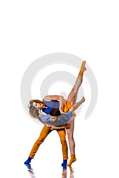 Young couple ballet dancing on white background