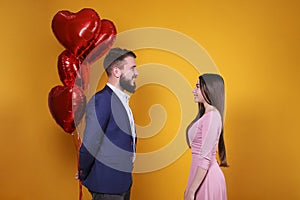 Young couple with a balloon heart.