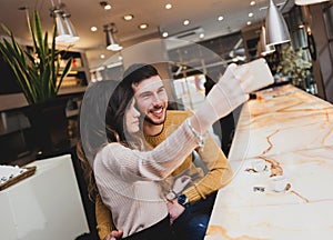 Young couple at the bar taking a selfie