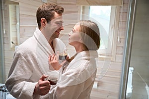 Young couple in the bathroom looking at each other