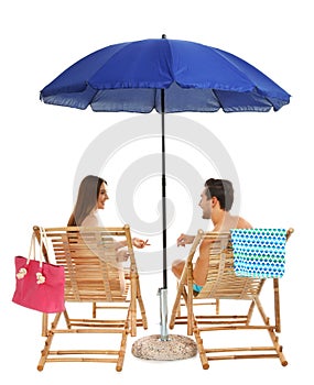 Young couple with beach accessories on sun  against white background