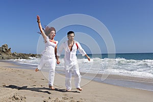 Young Couple at the beach jumping