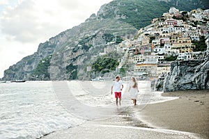 Young couple on the beach of Positano, Amalfi Coast, Italy