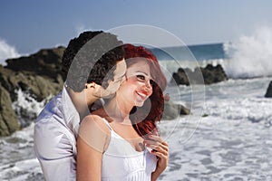 Young Couple at the beach showing affection