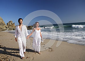 Young Couple at the beach walking