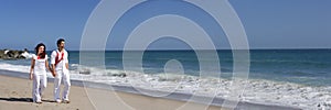 Young Couple at the beach walking