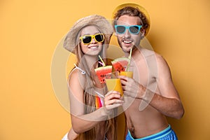 Young couple in beachwear with cocktails