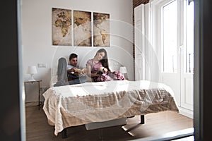 Young couple in bed entertained with book and a bunny photo