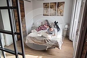 young couple in bed entertained on their computer and tablet photo