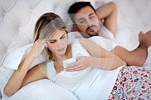 Young couple in bed having problems and crisis