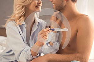 Young couple on bed pregnancy test check