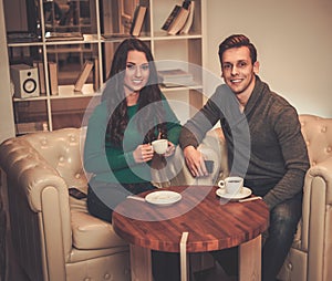 Young couple behind table discussing