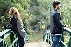 Young couple being in a conflict in the park.