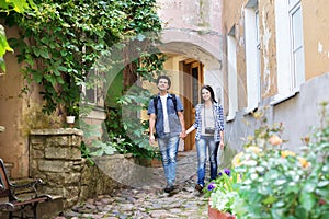 Young couple being tourists exploring an old town