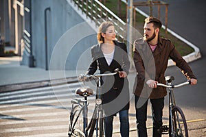 Young couple with on a bicycle opposite city