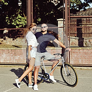 Young couple with a bicycle outdoor