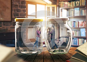 Young couple in big glass jars, loneliness concept