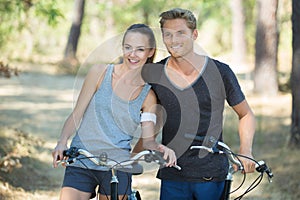 Young couple on bike ride in forest