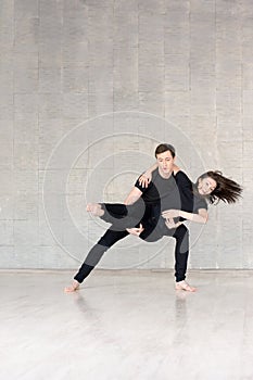 Young couple in black dancing.