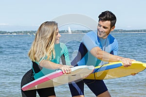 Young couple bodyboard surfers