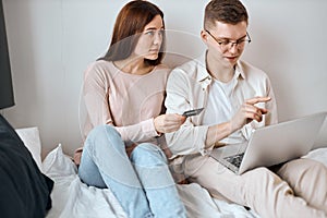 Young couple booking hotel, buying tickets for travel, trip