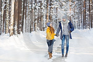 Young couple in a bright clothes walk and laught in a forest photo