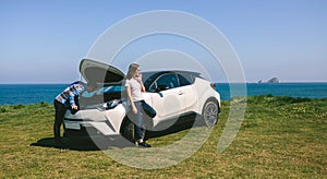 Young couple with the broken down car